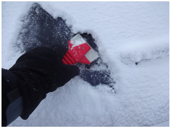 A 3D printing ice/snow scraper in use.